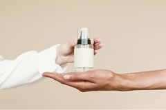 Male and female hand holding perfume fragrance.