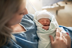 Image Woman holding a newborn baby