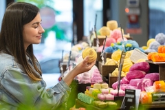 A woman holding a Lush bath bomb.