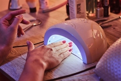 nail care in UV light getting manicure