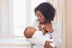 Mother feeding an infant with bottle