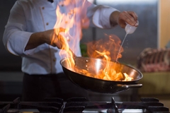 Image fire in wok held by chef
