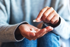 Image Person taking supplements.
