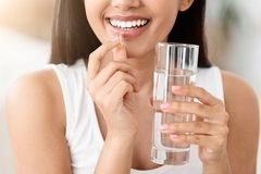 Image Woman taking supplements