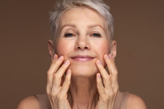 Older woman applying skin care for healthy aging