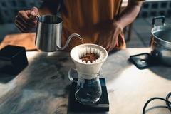 Image Drip coffee, barista pouring water on coffee ground with filter