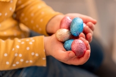 Image A child holding Easter eggs