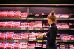 Image Female shopper buying meat in the supermarket.