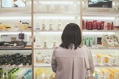 Image woman looking at cosmetic shelf