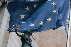 EU flag on building with statue