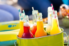 Image Bottles of lemonade standing in a colorful green bucket