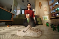 Image woman spraying dirty shoe with spray
