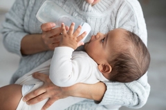 Image baby drinking out of bottle