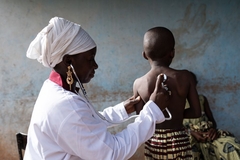Image Doctor checking lungs of child in Africa