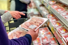 Image Buyers checking meat packs in a store.
