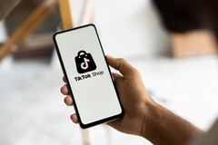 Image man holding phone selling beauty on e-commerce TikTok Shop in Japan