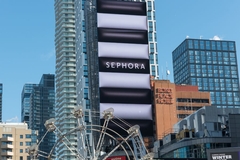 sephora logo on building screen in city square