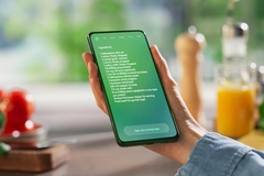 Hand Holds a Smartphone Displaying an AI Chatbot Interface.