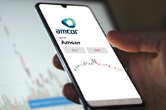 Image Holding phone displaying Amcor logo.