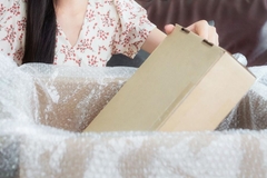 A woman holding a paper-based box