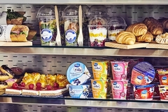 A shelf with food and yogurt on it