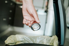 throwing away a coffee pod