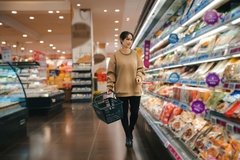 Image a young woman shopping in the supermarket