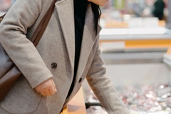 Image Woman reaching for food packaging in store.