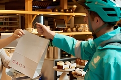 A person handing a bag to a delivery man