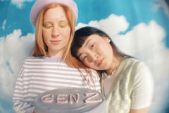 Image Two girls holding a cake that says Gen Z.