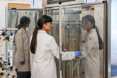 Image A person in white lab coats doing tests