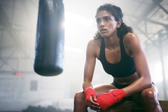 Image boxer rests leaning on knees
