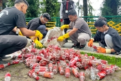 Image A group of people picking up plastic bottles