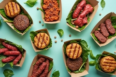 Image different types of meat analogs against a green background