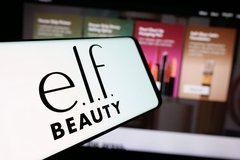 A  phone with elf beauty on it in front of its website.