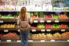 Image Women looking at fresh fruit and vegetables in the supermarket.