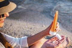 Image woman applying sun cream