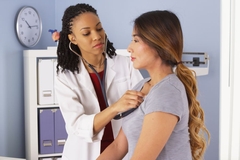 Image Doctor checking heart rate