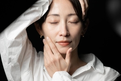 mature woman touching her face