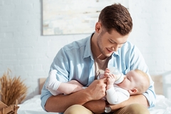 Image Man feeding baby