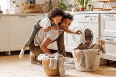 Image father and son doing laundry having fun