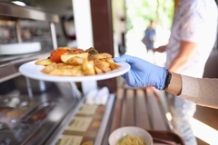 Image Person serving fried potatoes
