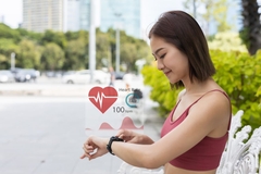 Image Woman checking heart rate on smartwatch