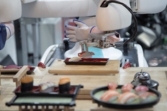 Image robotic arm placing sushi in a tray