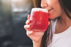 Image woman sips on cold juice