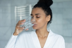 Image Woman drinking water for skin health