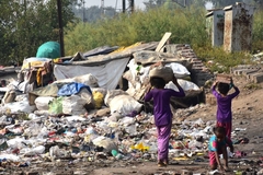 People carrying loads of garbage