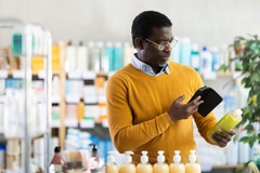 Image man scanning personal care products barcode with QR code