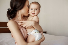 Image mother carries happy baby