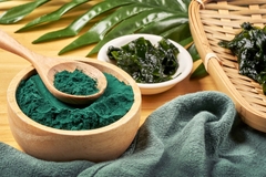 Image Spirulina powder in a bowl and seaweed food product.